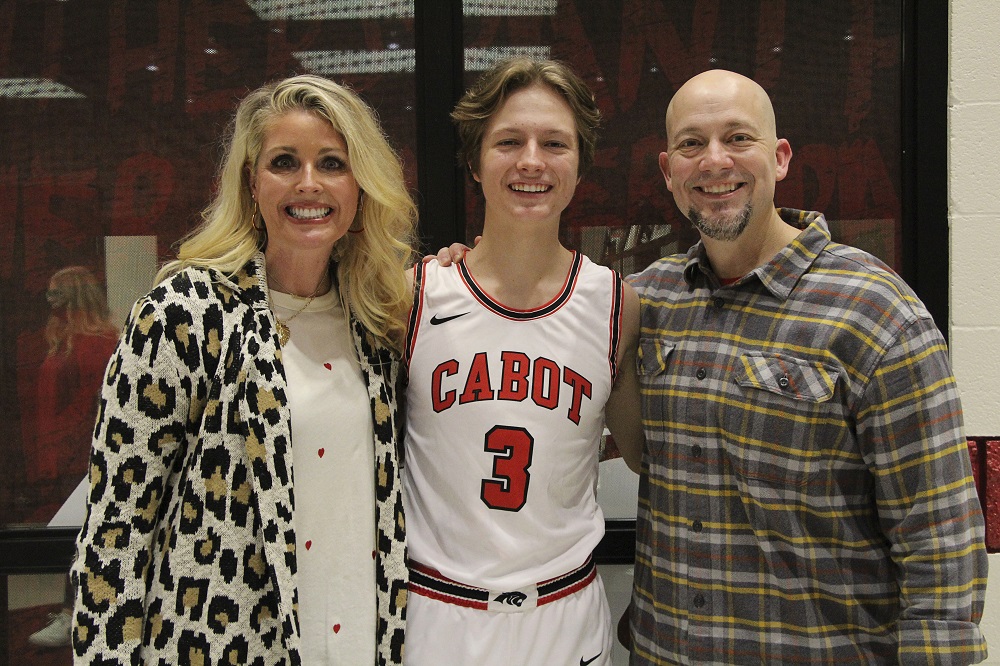 Boys BBall Senior Sam Owen with parents being recognized for senior night 2021